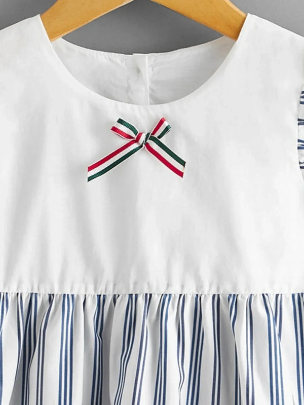baby striped dress with white top and blue vertical stripes on skirt with red green bow detail