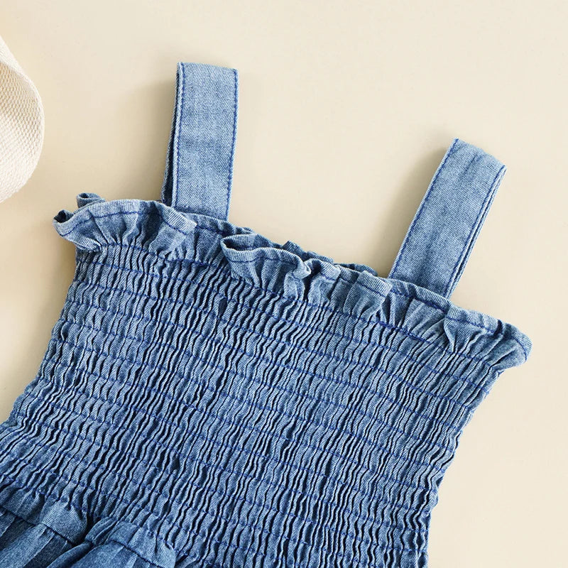 blue denim summer romper for babies with smocked bodice and ruffle trim shoulder straps