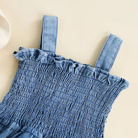 blue denim summer romper for babies with smocked bodice and ruffle trim shoulder straps