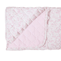 Pink and white quilted super soft baby play mat with leaf pattern folded at corner