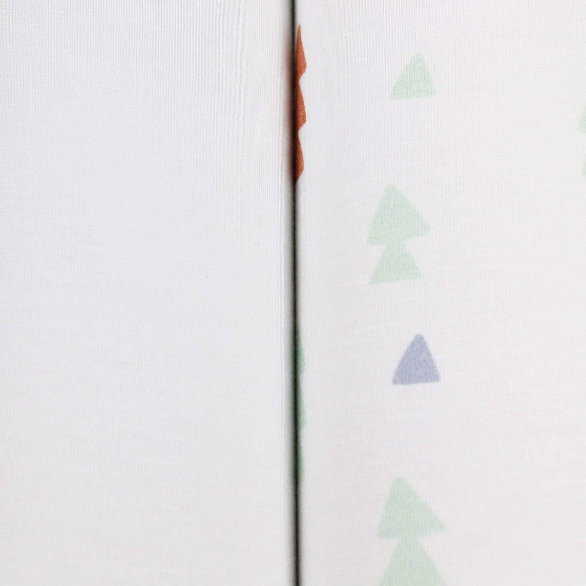 Goosewaddle newborn swaddle blankets in white with pastel tree pattern, soft cotton fabric