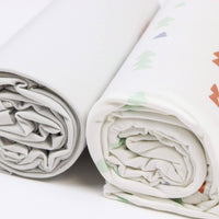 White and cream newborn swaddle blankets with pastel tree patterns for babies