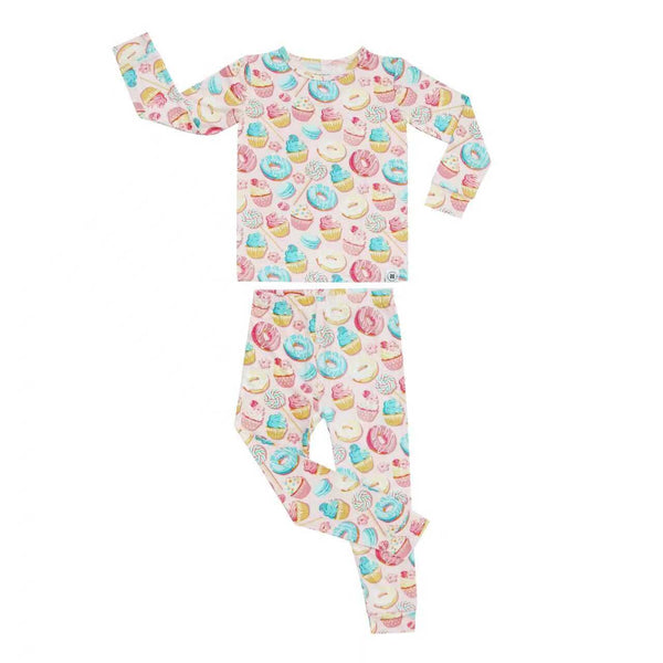 A two-piece children's pajama set featuring a long-sleeve top and matching pants, both printed with a colorful pattern of donuts, cupcakes, and pastries on a white background.
