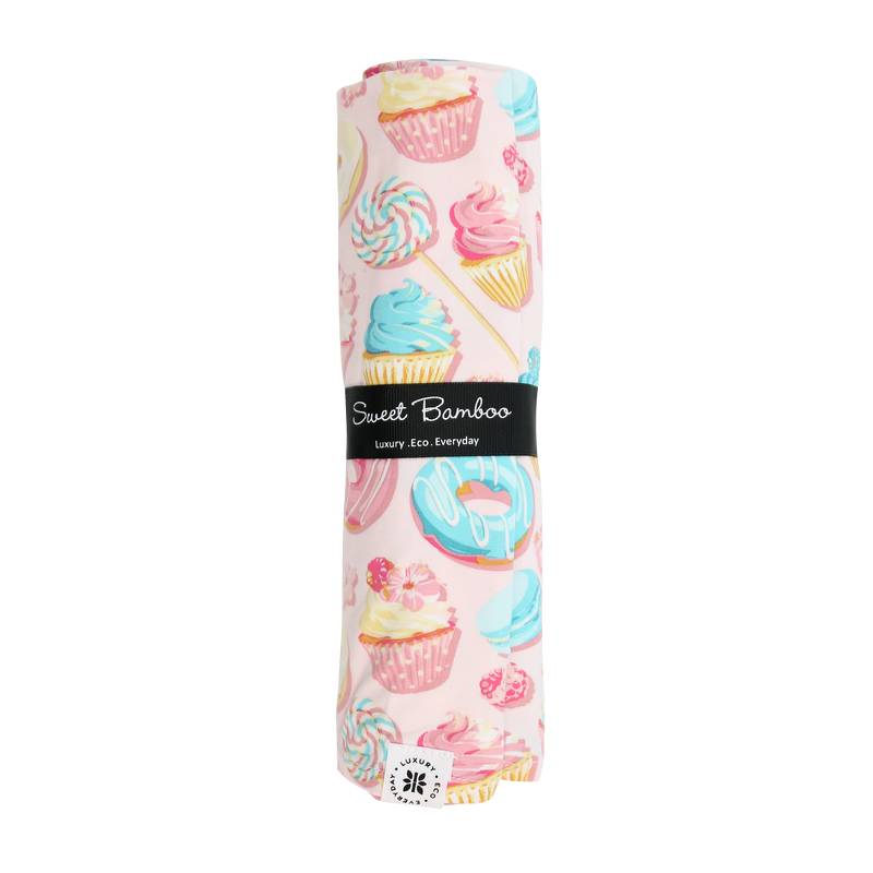 Sweet Tooth Swaddle in cupcake print: silky single-layer baby wrap for cozy, secure snuggle.