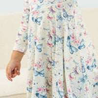 Watercolor butterfly swirly girl dress with long sleeves, knee-length, empire waist.