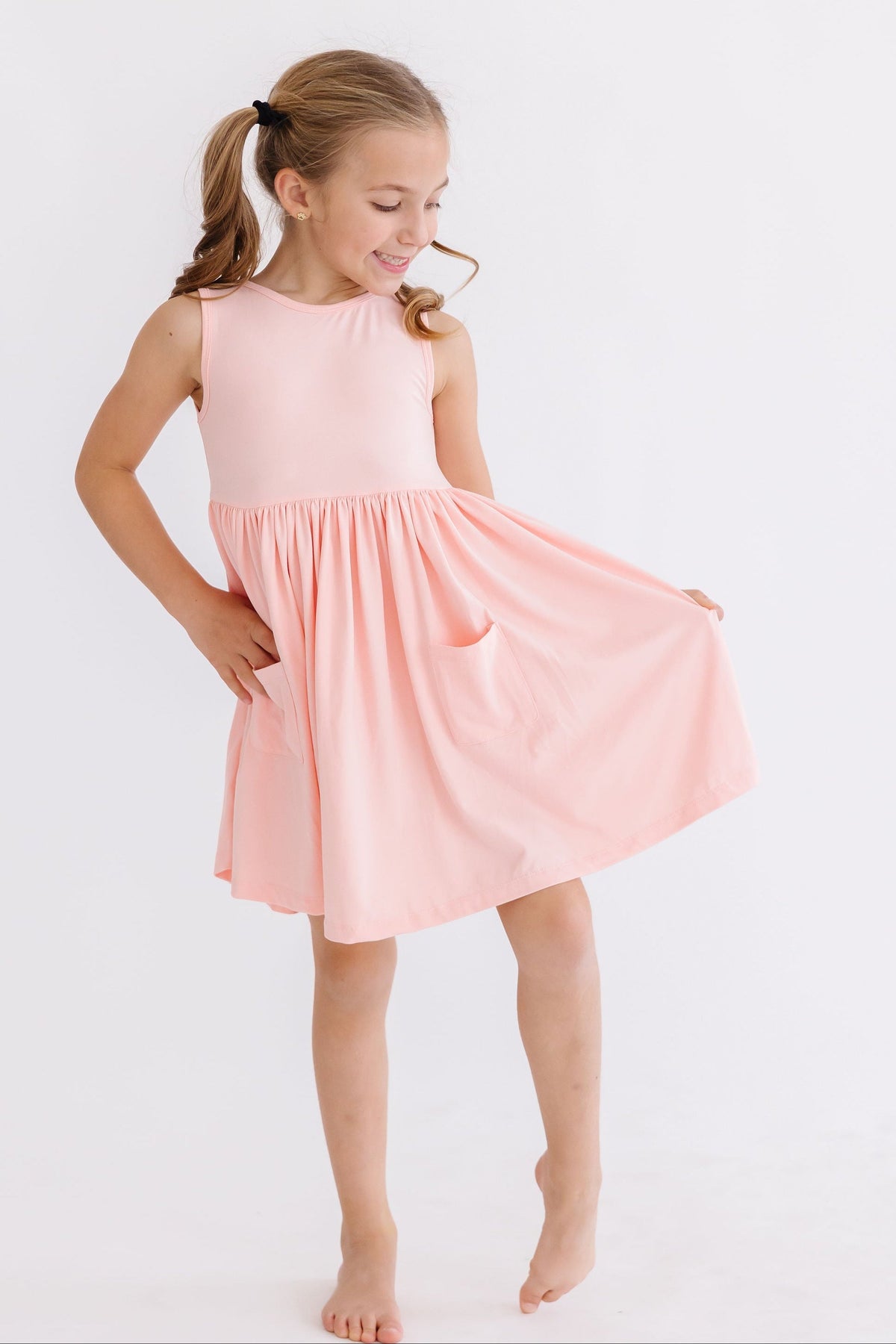 Girls pink Mila Rose Twirl Pocket tank dress with sleeveless design and pocket detail