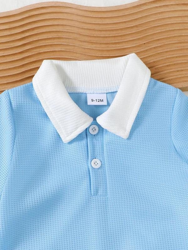 Light blue toddler knit shorts set top with white collar for ages 9 to 12 months displayed on wooden surface