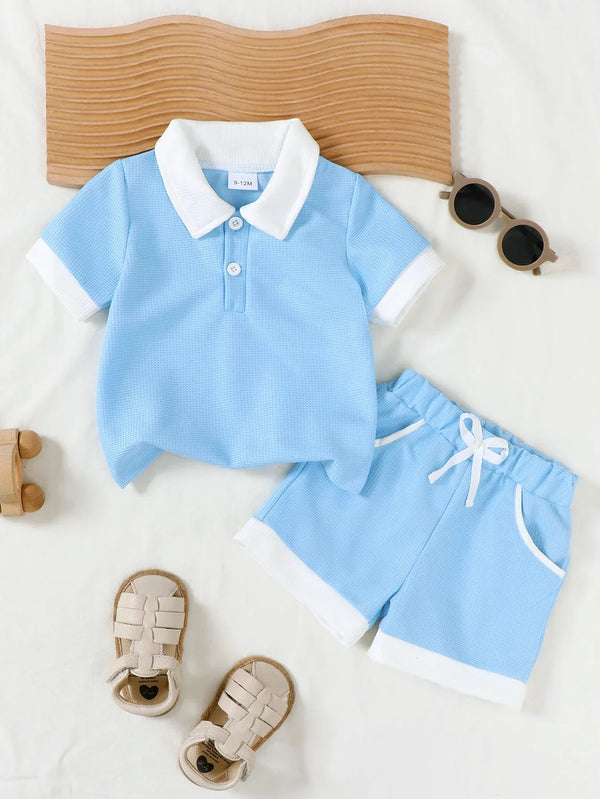 light blue toddler knit shorts set with white collar and trim laid flat with tan headband and beige sandals
