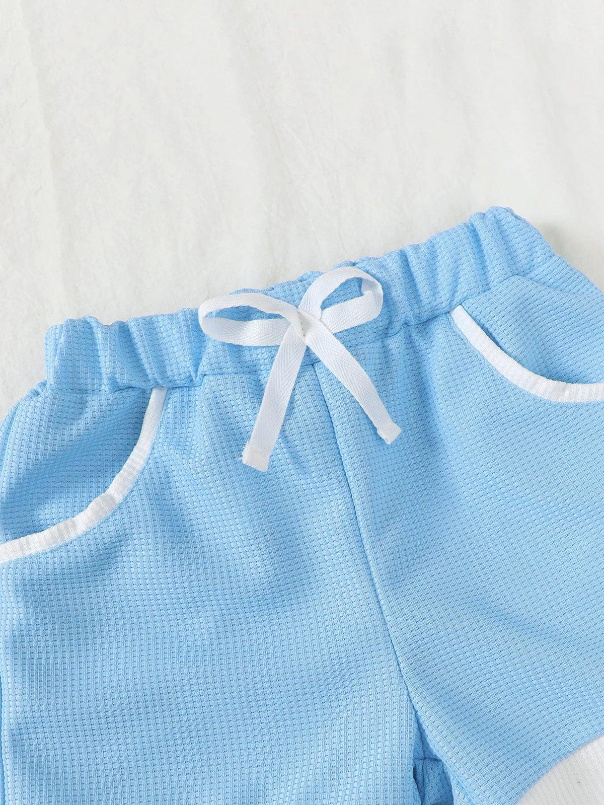 Light blue toddler knit shorts set featuring white trim and drawstring waistband for toddlers