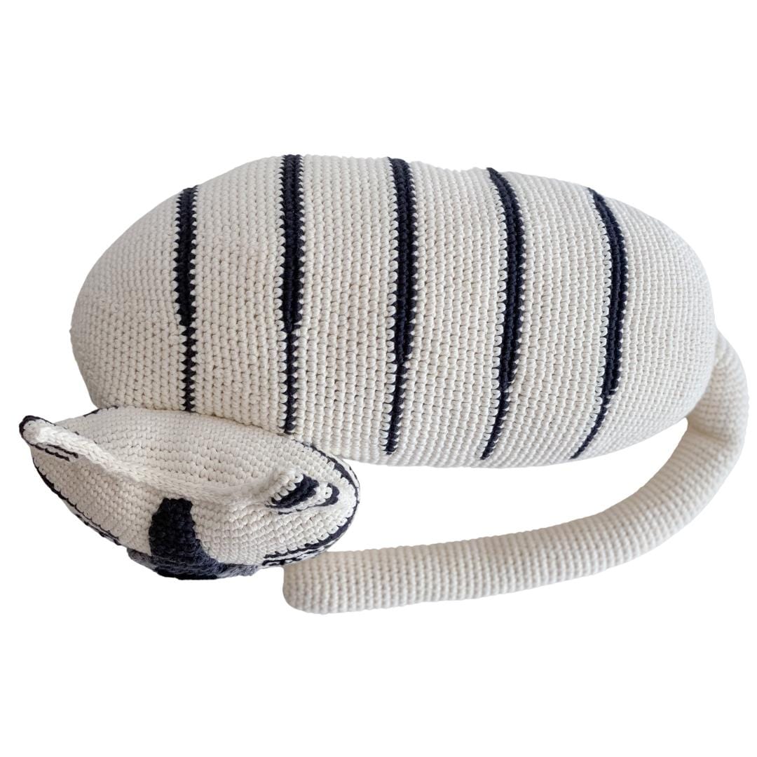 White organic cotton crochet tiger with dark stripes in a relaxing pose. Soft stuffed animal toy for children.