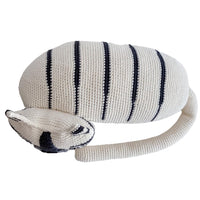 White organic cotton crochet tiger with dark stripes in a relaxing pose. Soft stuffed animal toy for children.