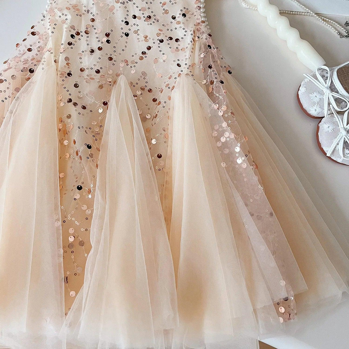 close-up of light pink tulle party dress for girls with sequins and soft fabric layers