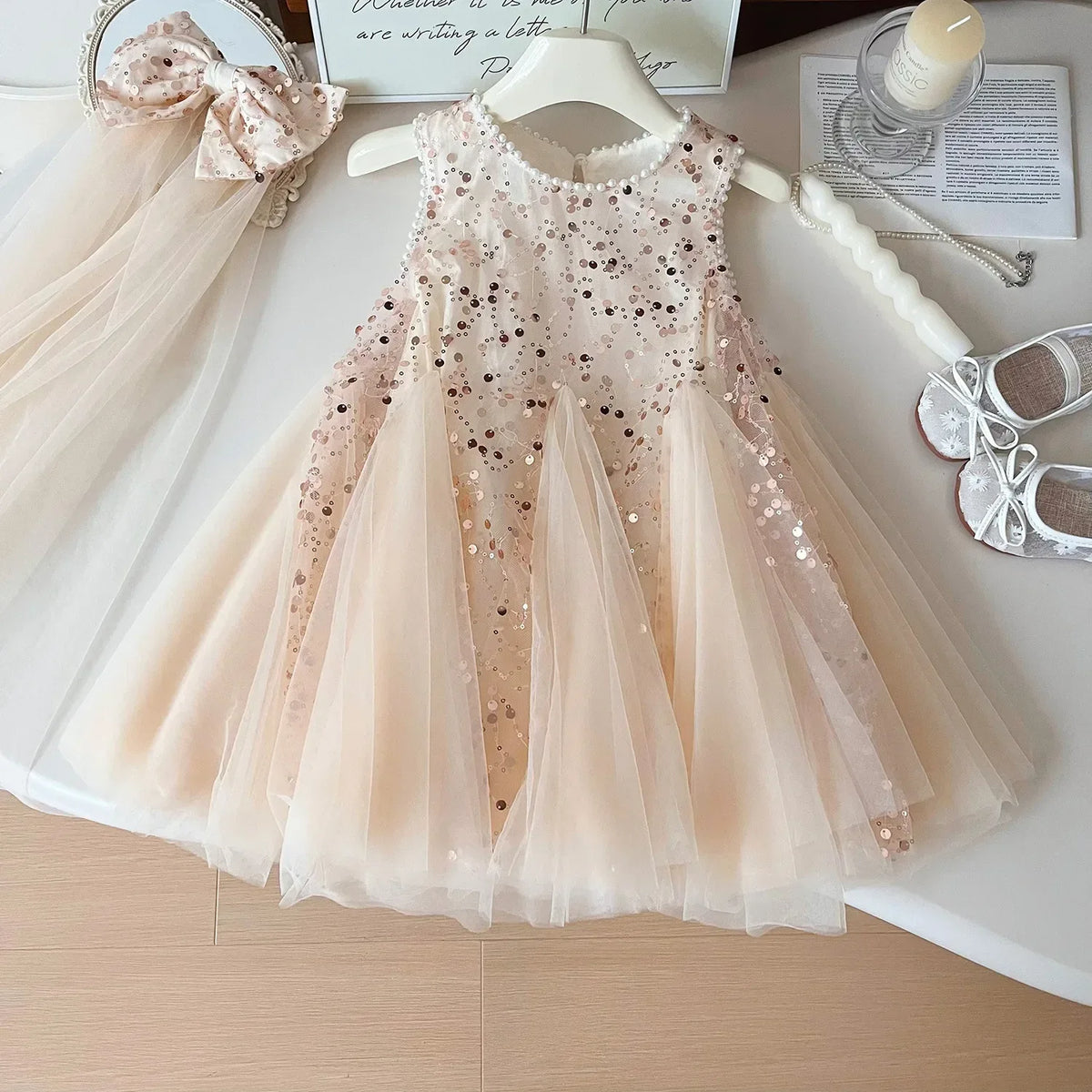 light pink tulle party dress for girls with sequins for toddlers and young girls displayed on hanger