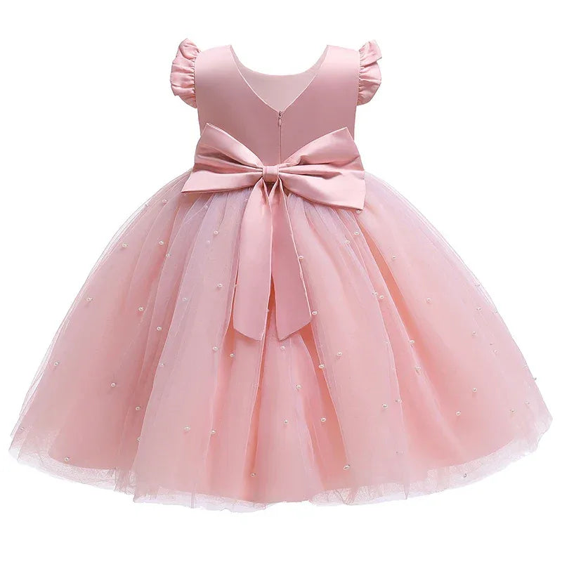 Pink girls tulle party dress with pearl accents and large bow, toddler size