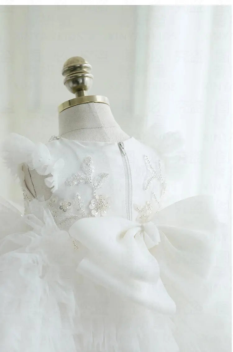 White tulle special occasion dress for girls with floral sequin details and large bow for toddlers