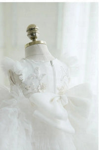 White tulle special occasion dress for girls with floral sequin details and large bow for toddlers