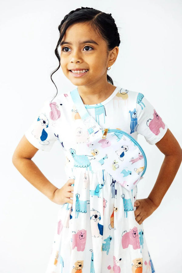 girl wearing white short sleeve twirl dress for girls with colorful animal prints smiling