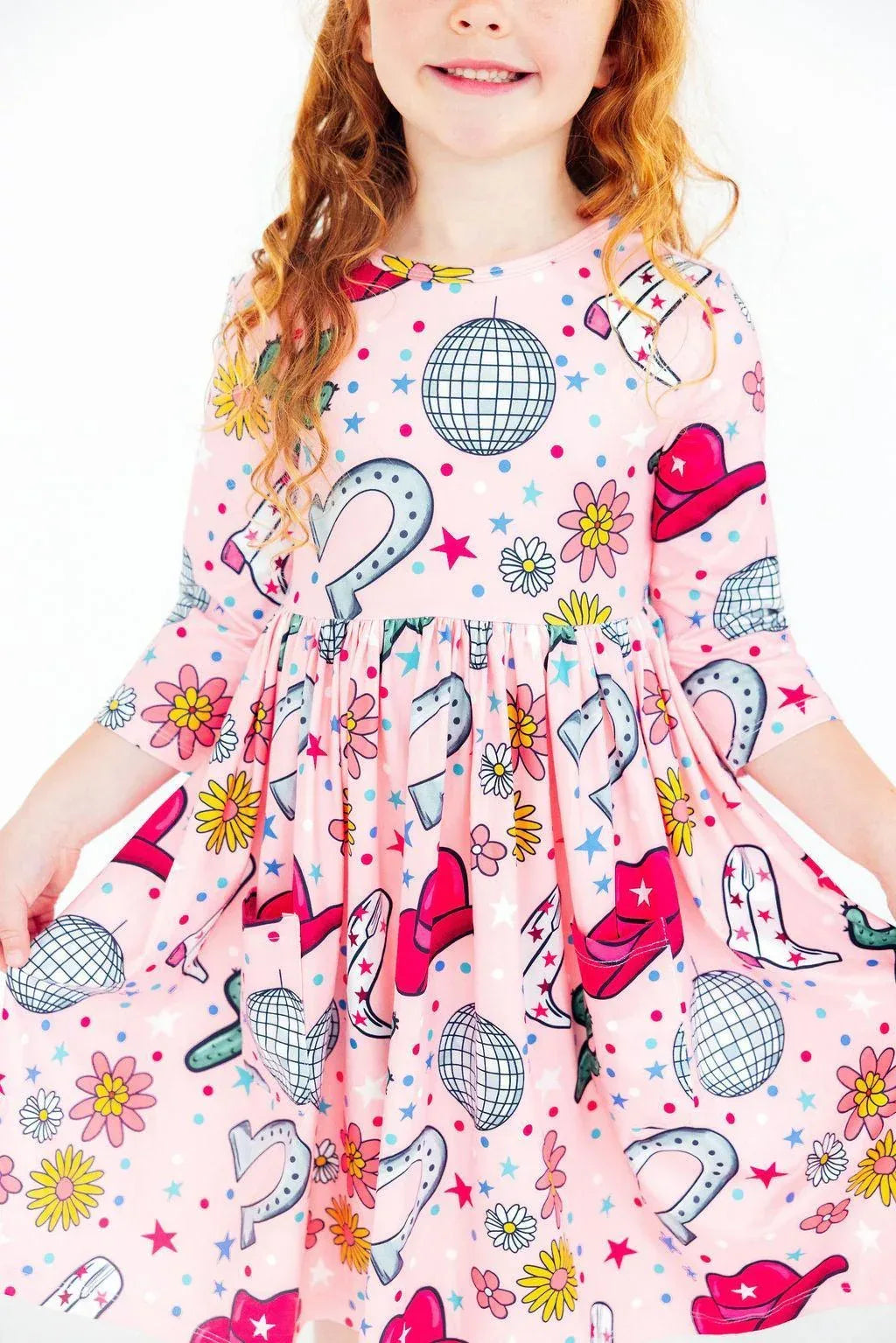 Girls pink twirl dress with long sleeves and colorful cowboy hat and disco ball print for ages 4 to 6