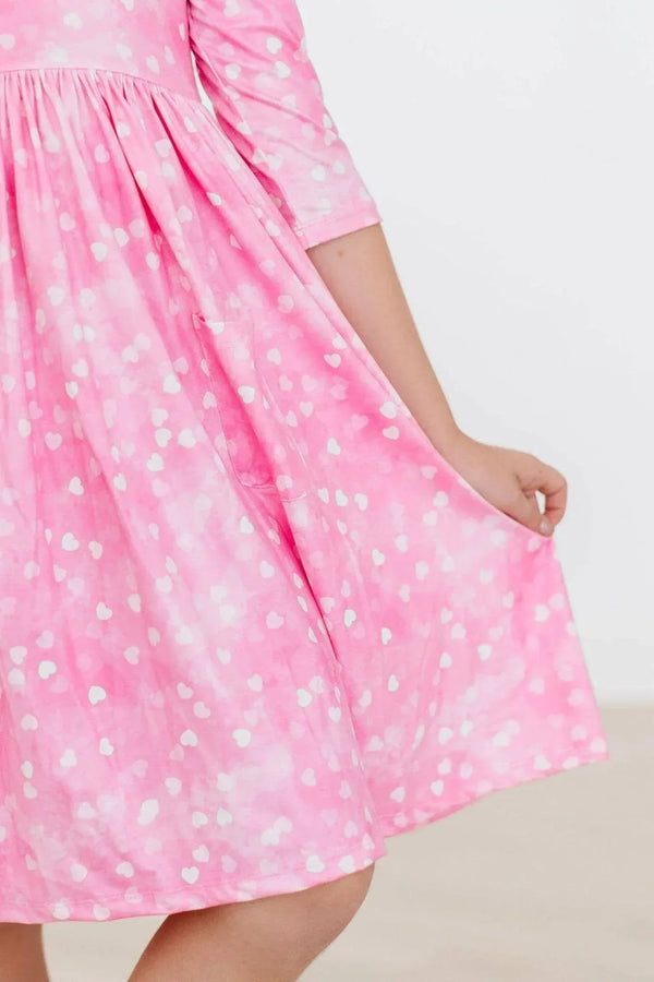 Girls pink twirl dress with white heart print and 3/4 sleeves by Mila & Rose