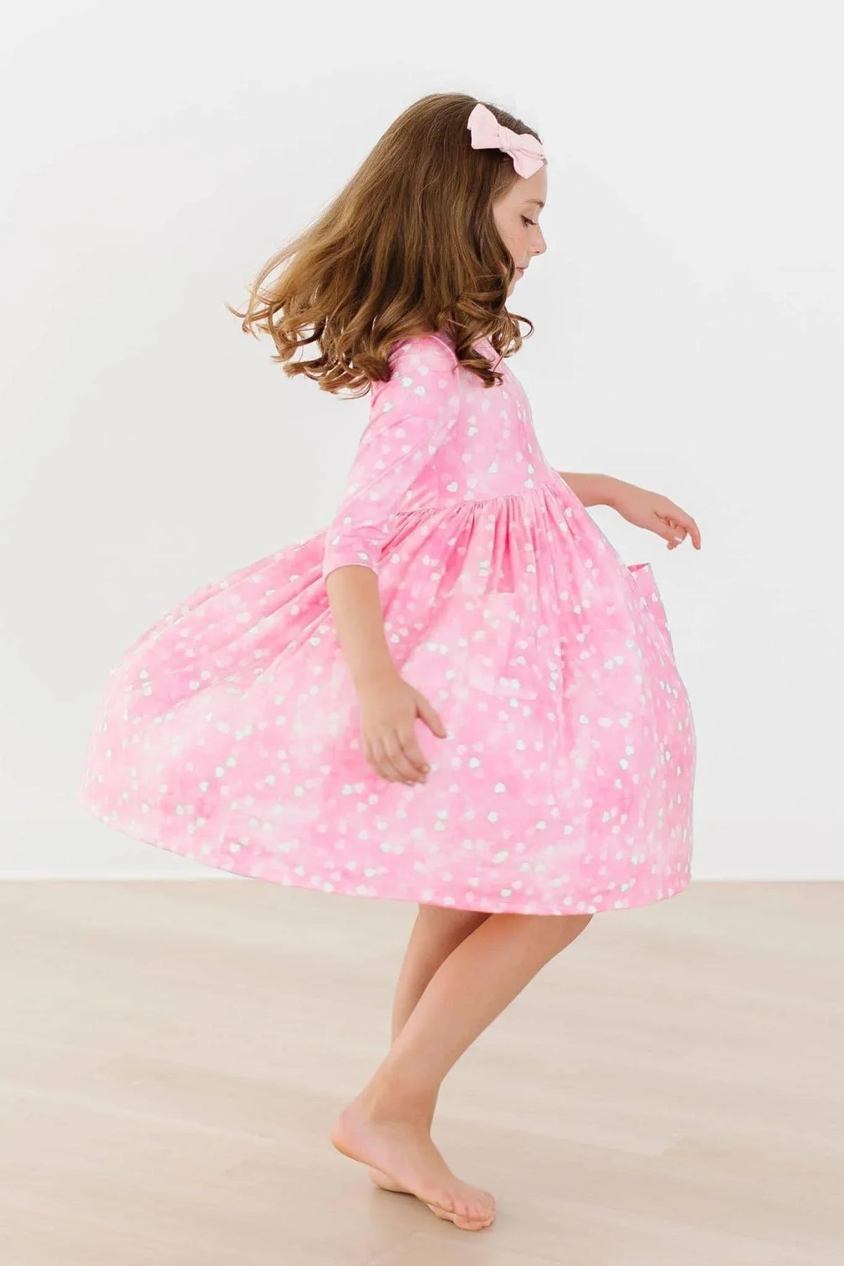 Girls pink polka dot twirl dress with 3/4 sleeves and pocket by Mila & Rose
