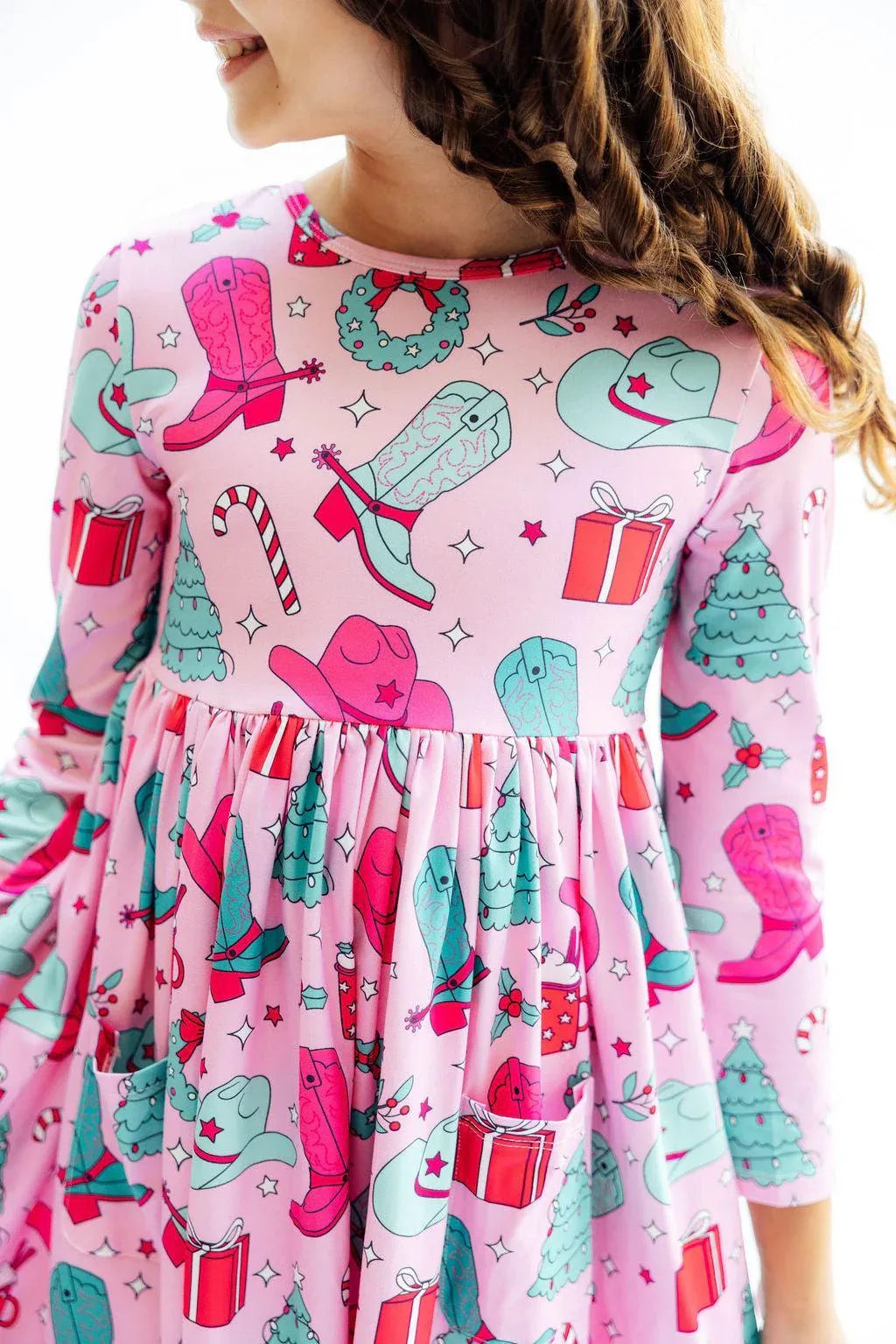Girls pink twirl dress with long sleeves and festive holiday print including boots and gifts