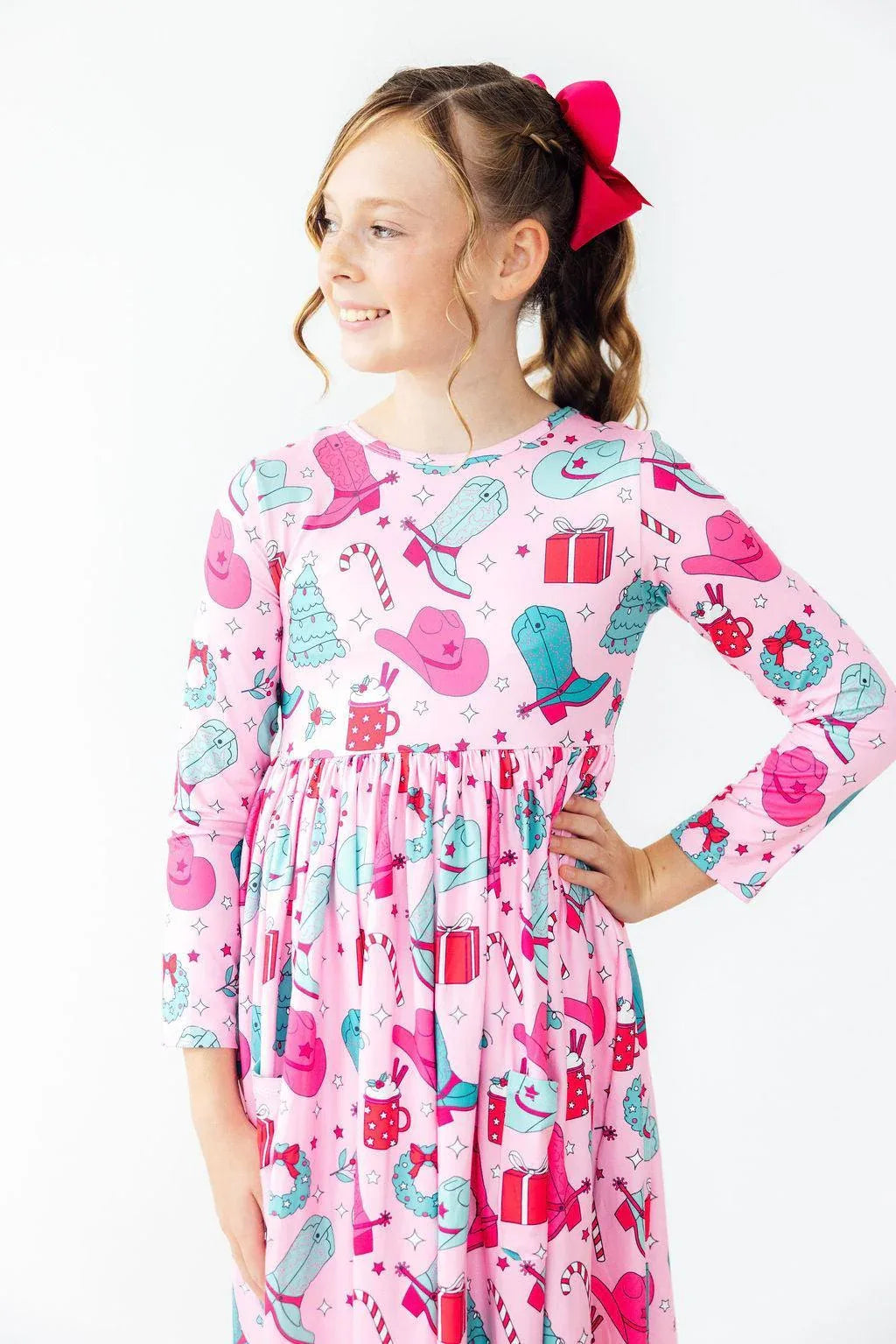 Girls long sleeve pink twirl dress with colorful holiday print and pockets for kids