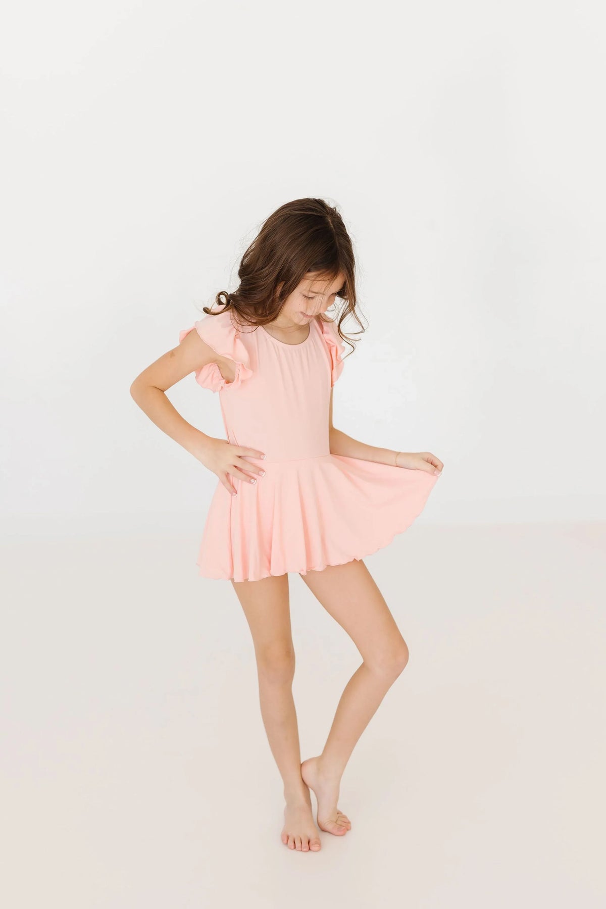 Girls light pink twirl leotard with short sleeves and flutter detail size small