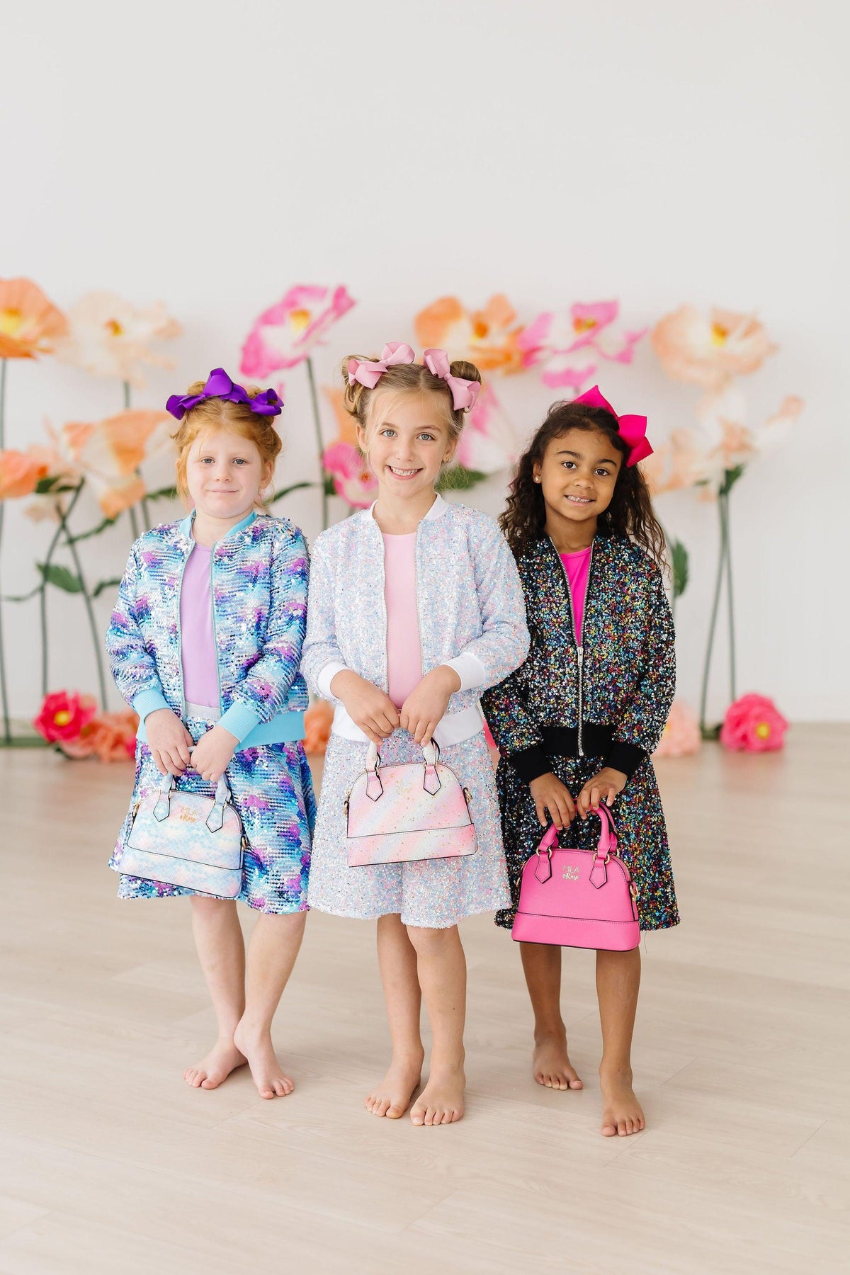Girls sequin skorts in blue, white, and black with vibrant floral prints and twirl skort design