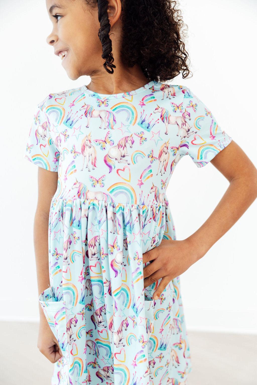 toddler girl wearing Mila & Rose unicorn dress for toddlers with twirl pocket design smiling and posing