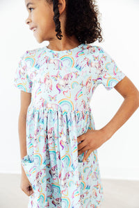 toddler girl wearing Mila & Rose unicorn dress for toddlers with twirl pocket design smiling and posing