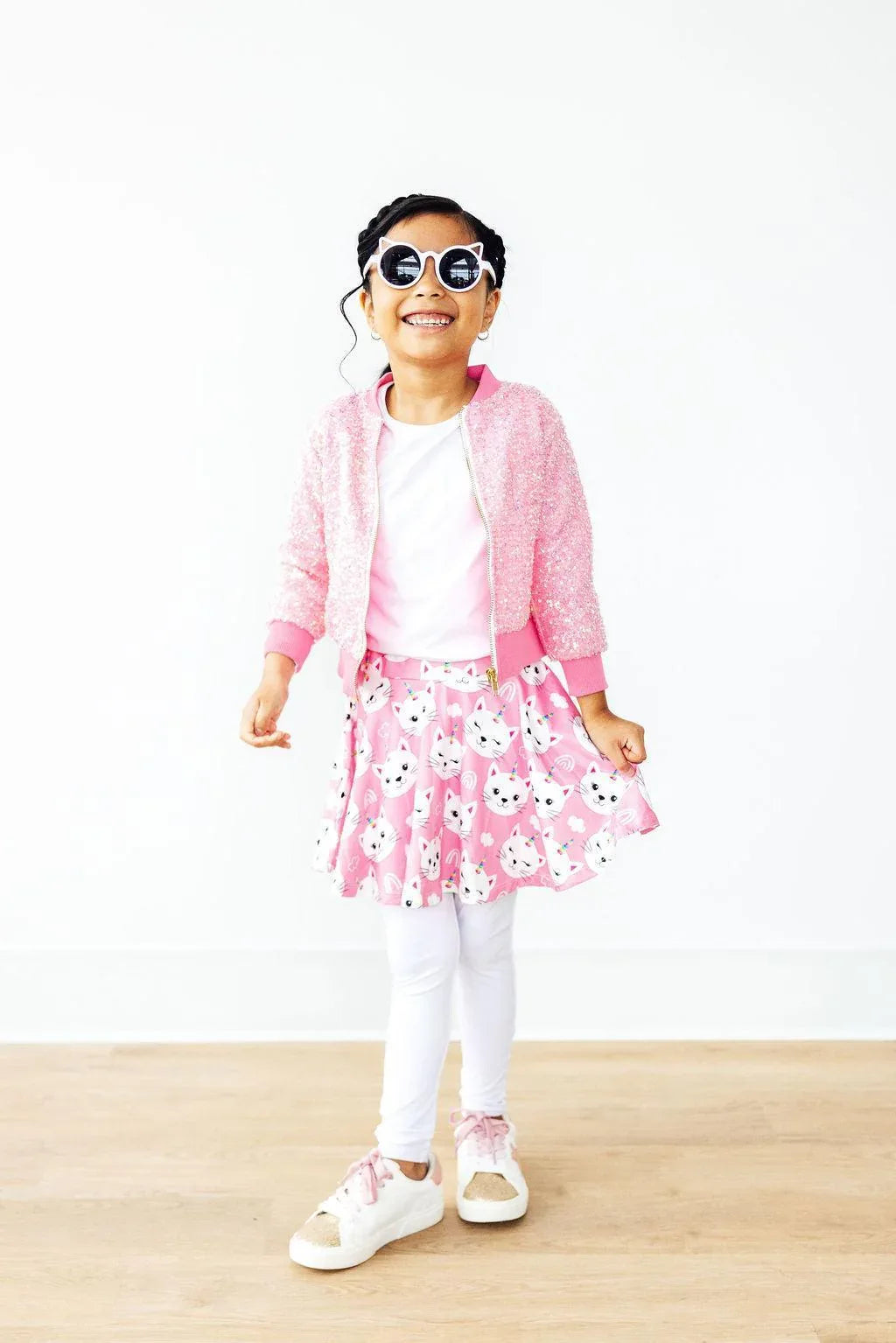Girls pink unicorn kitty leggings skirt for girls with white leggings, white shirt, and pink cardigan