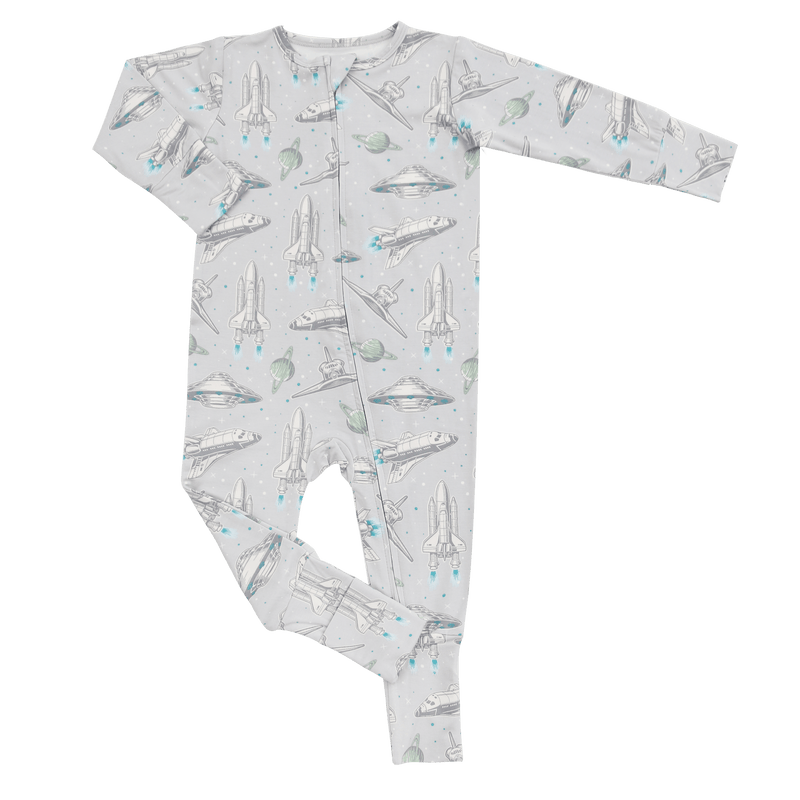 Children's onesie with space-themed print on a green background