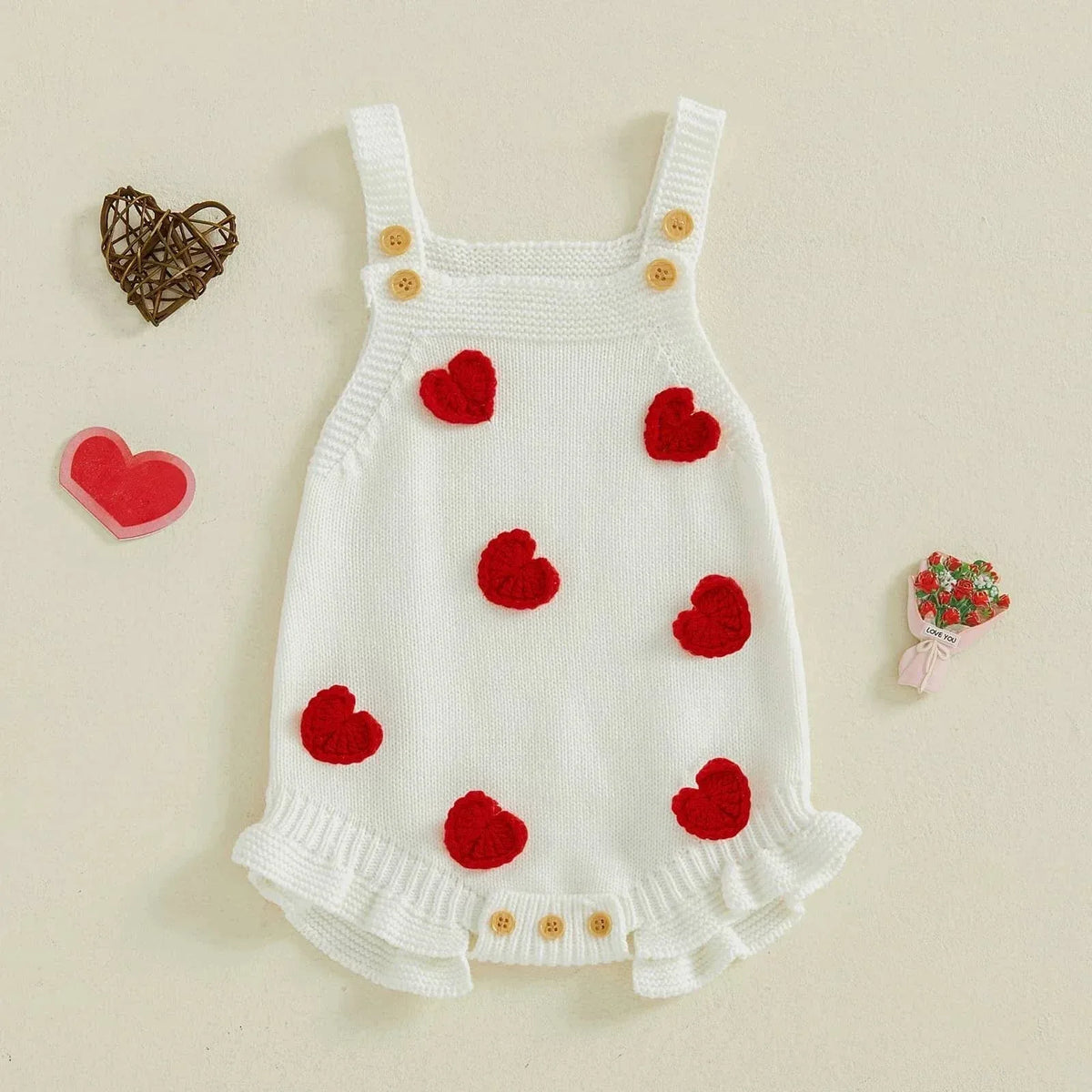 White cotton Valentine's Day baby romper with red heart accents and wooden buttons