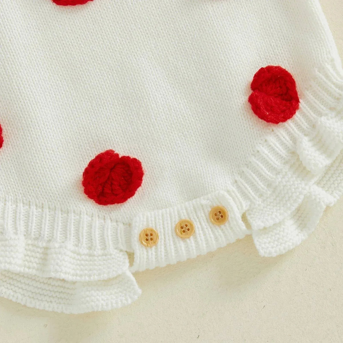 White knitted cotton Valentine's Day baby romper with red heart accents and button closure