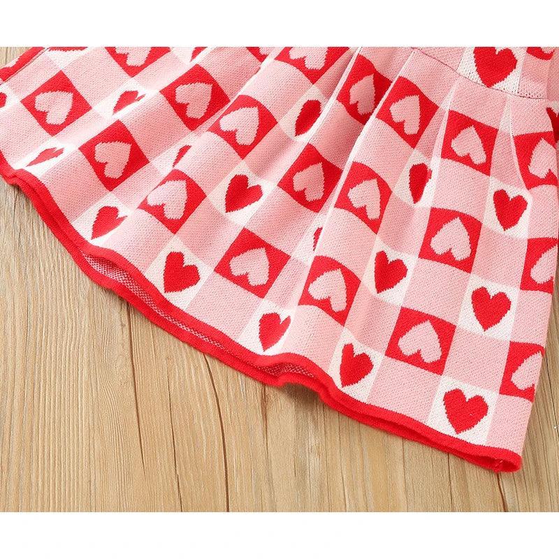 Red and pink knitted Valentine's Day dress for little girls with heart pattern made from soft fabric
