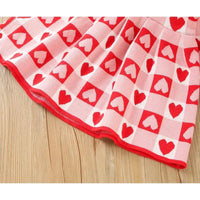 Red and pink knitted Valentine's Day dress for little girls with heart pattern made from soft fabric