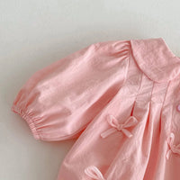 Soft pink baby girl bubble romper with puff sleeves and decorative bows for babies and kids