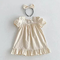 Cream vintage baby girl outfit made of soft cotton with puff sleeves and lace detailing