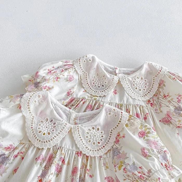 White cotton vintage baby girl outfit with pink floral print and lace eyelet collar