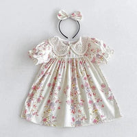 Vintage baby girl outfit in soft cotton with pink floral print dress and matching bow headband