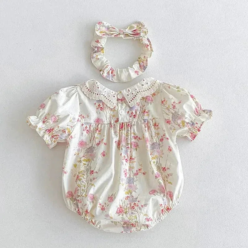 White cotton vintage baby girl outfit with pink floral print and lace collar with matching headband