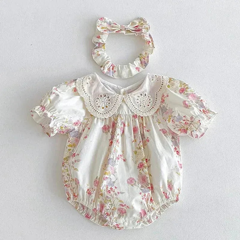 White cotton vintage baby girl outfit with pink floral print and lace collar with matching headband