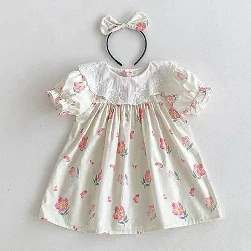 Vintage baby girl outfit in white cotton with pink floral print and lace collar, includes matching bow headband