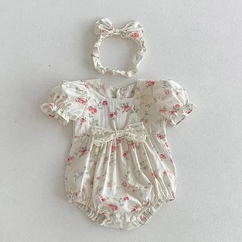 cream baby romper with pink vintage floral sibling outfits print and matching bow headband