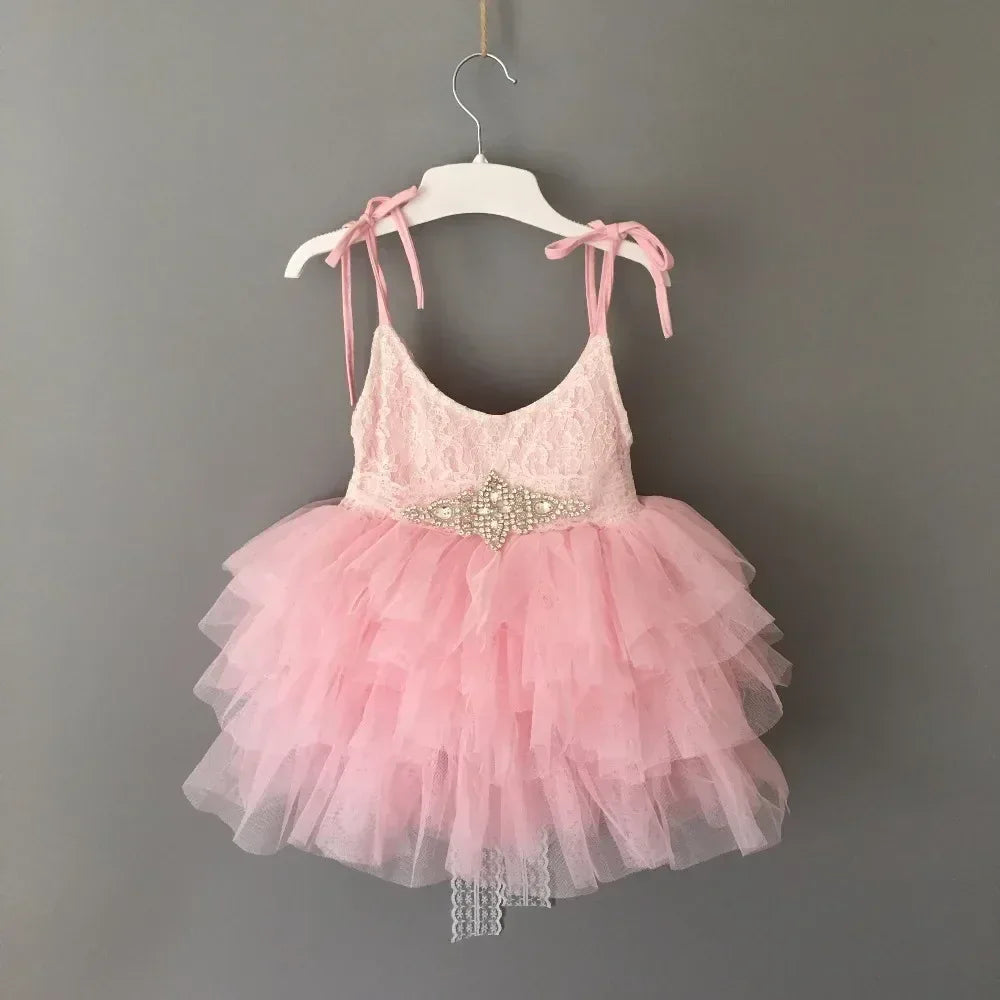 pink vintage baby girl dress for infants with lace bodice and layered tulle skirt with pearl embellishment
