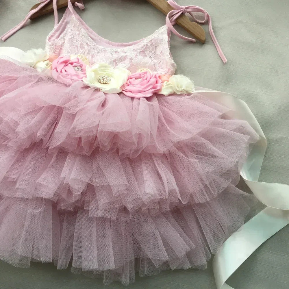 pink vintage baby girl dress with lace bodice and layered tulle skirt featuring floral waistband for infants
