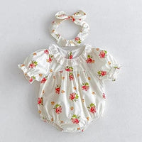 baby girl wearing white floral romper with lace collar and matching headband vintage sibling outfits for girls