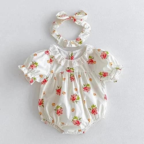baby girl wearing white floral romper with lace collar and matching headband vintage sibling outfits for girls