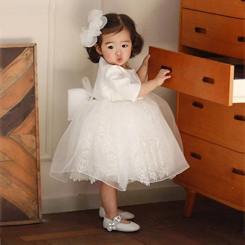 White voile special occasion dress for toddler girls with lace skirt and bow back detail