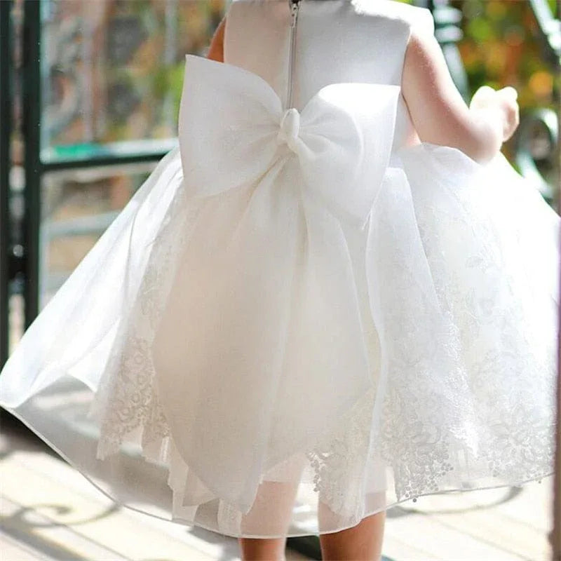White baby baptism dress with large bow back and lace overlay voile special occasion dress